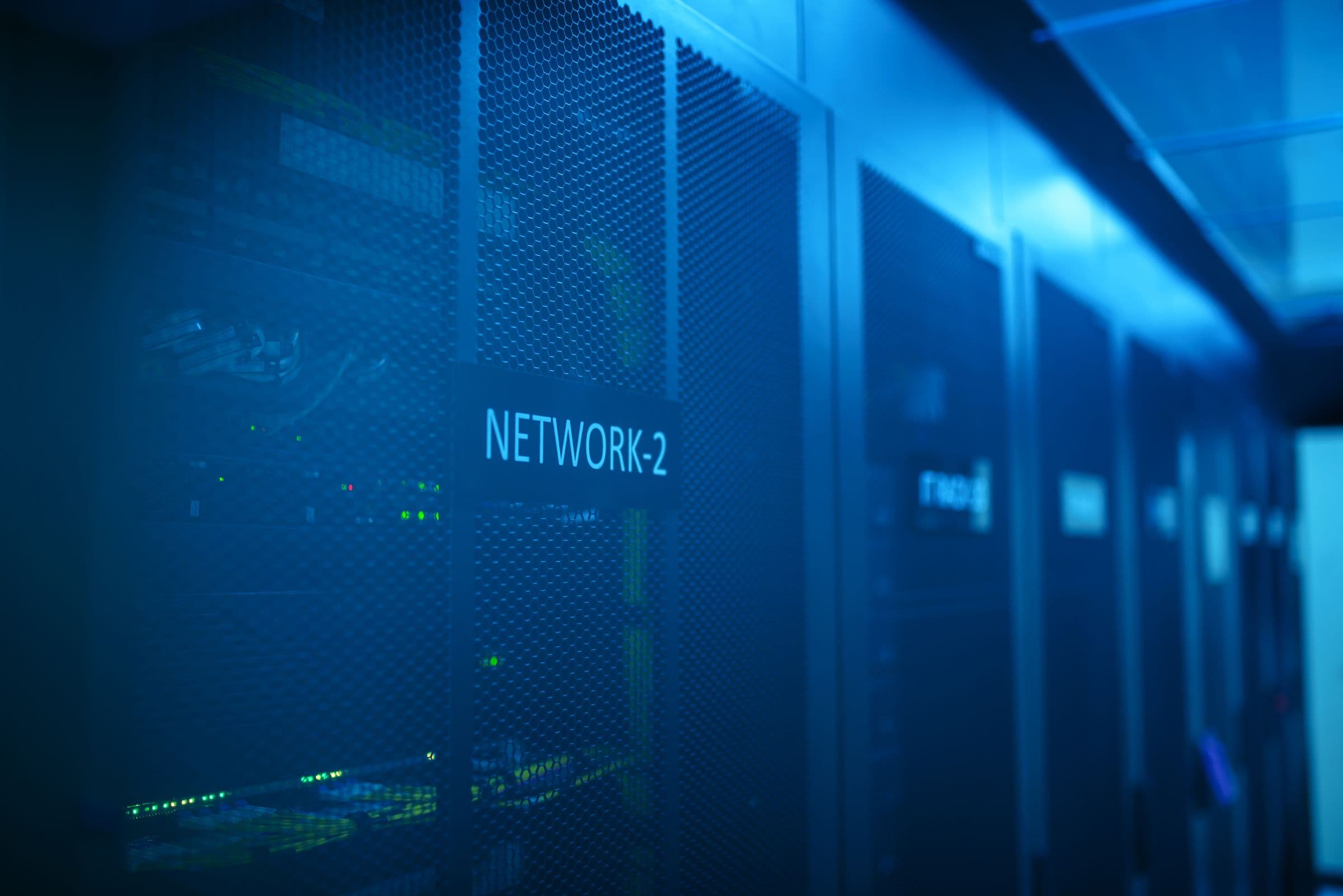 A server rack in a modern data center, lit in blue